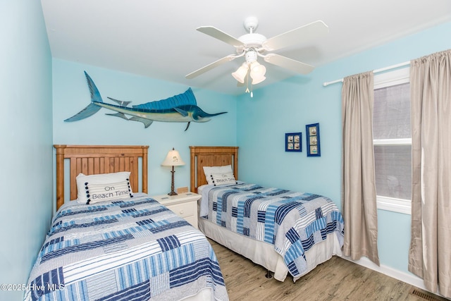 bedroom with ceiling fan and light hardwood / wood-style floors