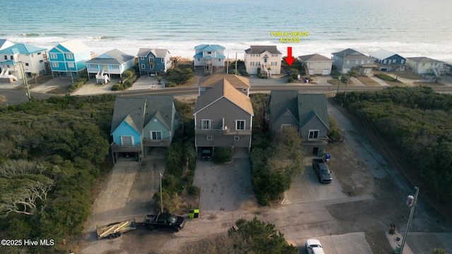 birds eye view of property featuring a water view and a view of the beach