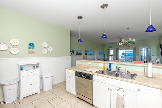 kitchen with decorative light fixtures, white cabinetry, stainless steel dishwasher, and sink