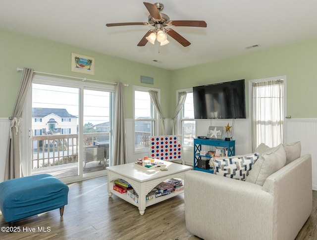 living room featuring ceiling fan and hardwood / wood-style flooring