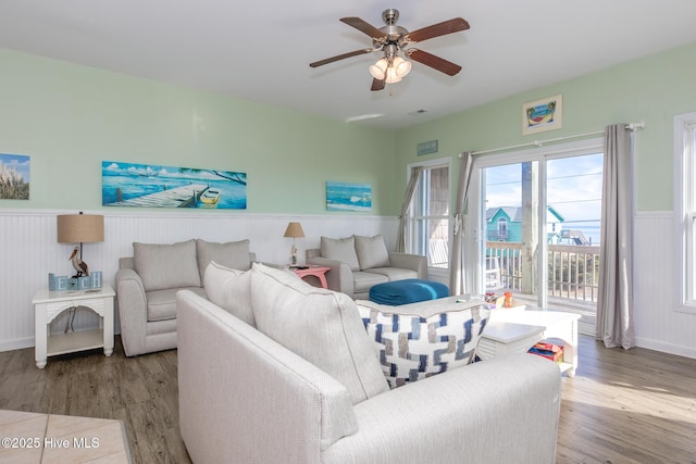 living room featuring ceiling fan and wood-type flooring