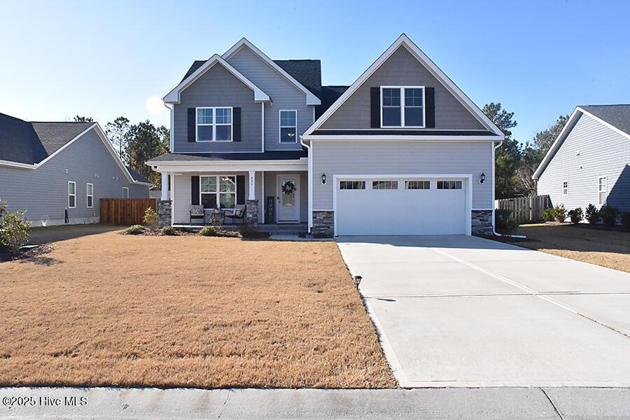 craftsman-style home featuring a garage and covered porch