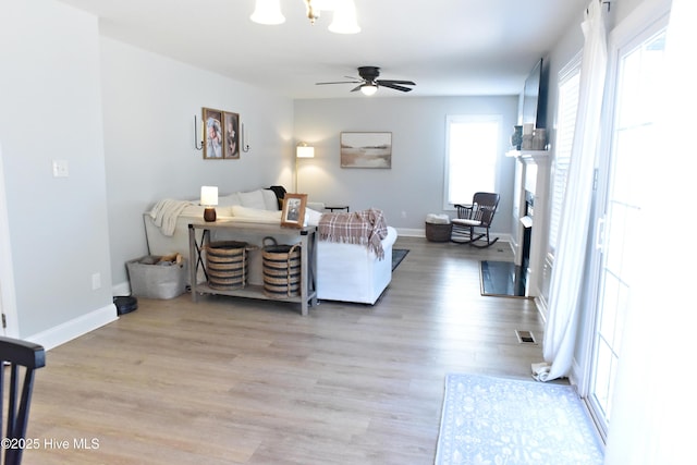 living room featuring ceiling fan and light wood-type flooring