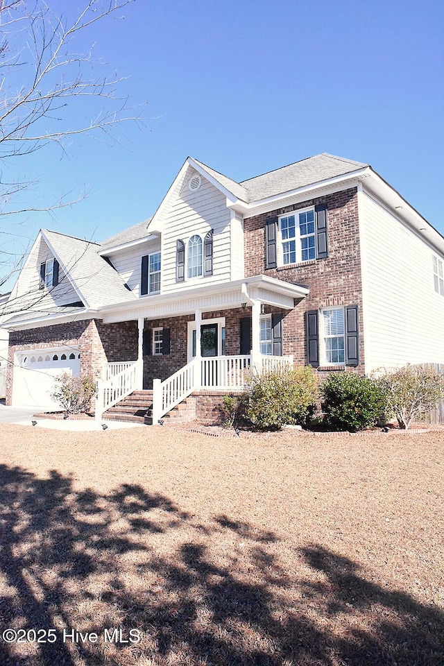 view of front of house featuring a porch and a garage