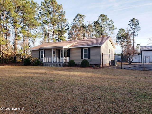 ranch-style house featuring a porch, cooling unit, and a front yard