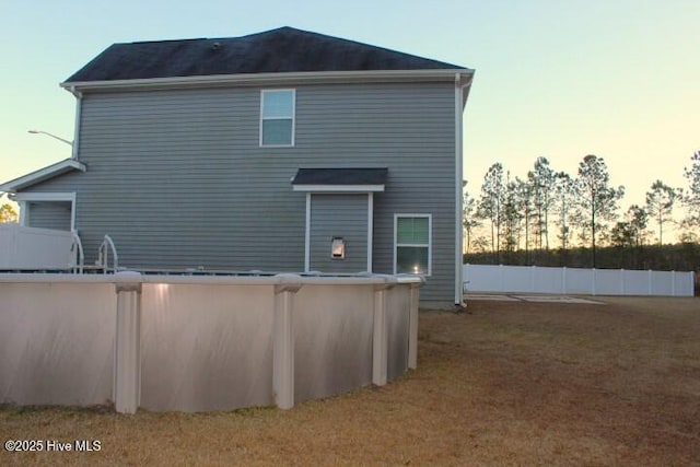 view of back house at dusk