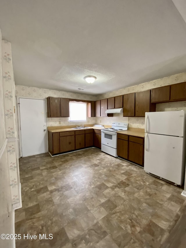 kitchen featuring white appliances and sink