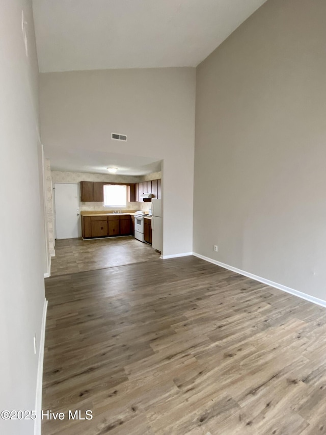 unfurnished living room featuring light hardwood / wood-style floors and sink