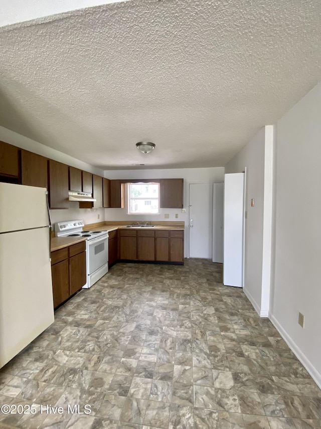 kitchen featuring a textured ceiling, white appliances, sink, and exhaust hood