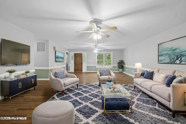 living room with ceiling fan and dark wood-type flooring