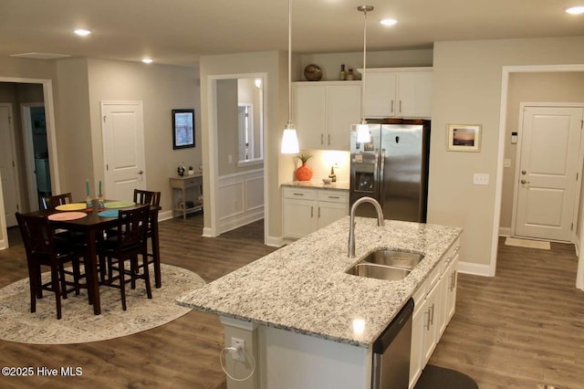 kitchen with white cabinetry, sink, an island with sink, and appliances with stainless steel finishes