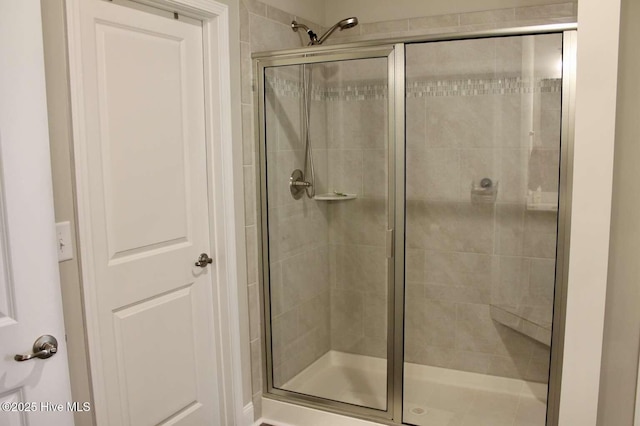 bathroom with a shower with shower door