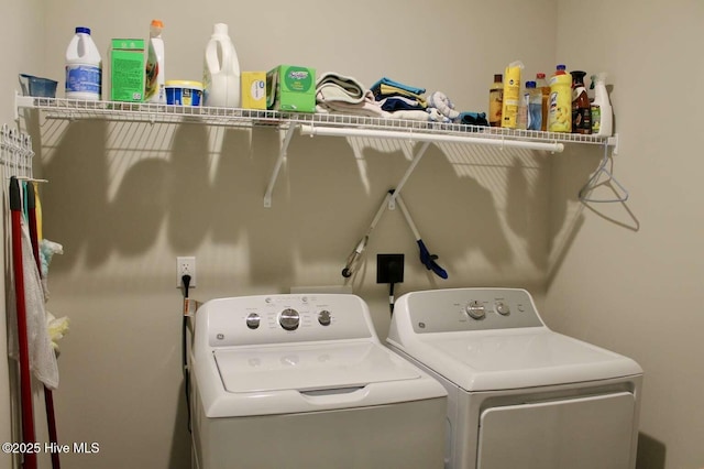 clothes washing area featuring separate washer and dryer