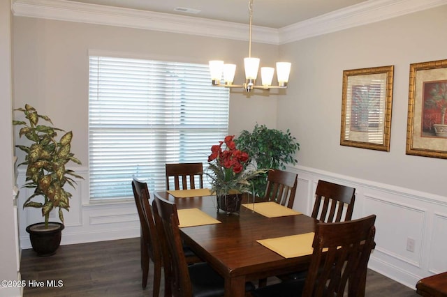 dining area featuring crown molding, a chandelier, and dark hardwood / wood-style floors