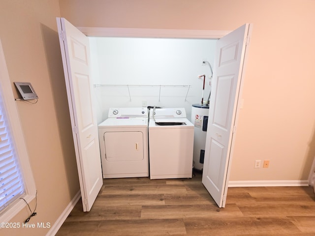 laundry area featuring separate washer and dryer, electric water heater, and light wood-type flooring