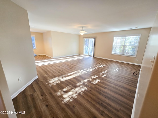 unfurnished room with dark hardwood / wood-style floors and ceiling fan