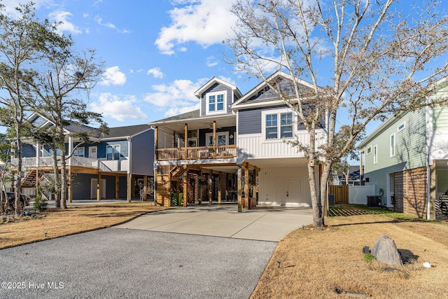 view of front of property featuring a porch, a carport, and cooling unit