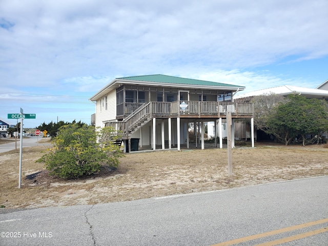 view of front of property with a sunroom and a deck