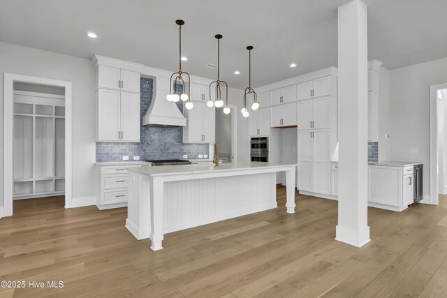 kitchen with sink, white cabinets, and light hardwood / wood-style floors