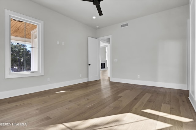 spare room with hardwood / wood-style floors and ceiling fan