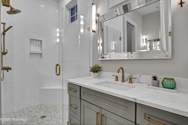 bathroom featuring vanity and a shower with shower door