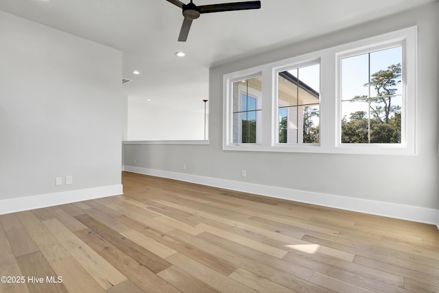 spare room featuring ceiling fan and light hardwood / wood-style flooring