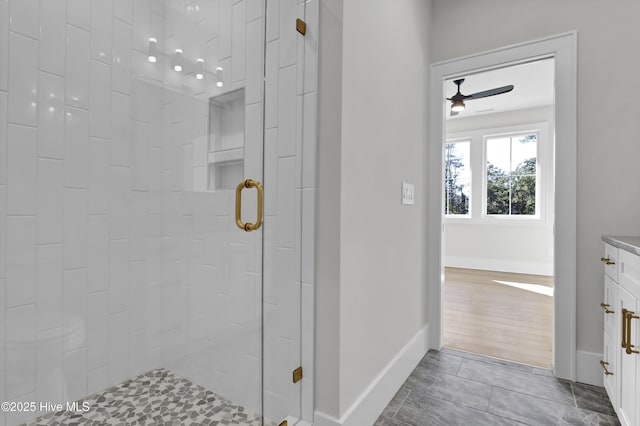 bathroom featuring vanity, an enclosed shower, and ceiling fan