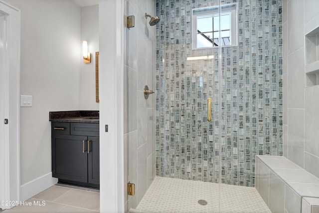 bathroom featuring vanity, tile patterned flooring, and a shower with shower door