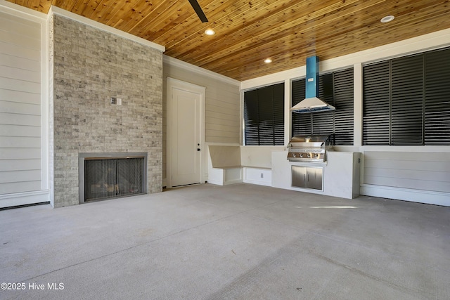 view of patio / terrace with an outdoor fireplace and area for grilling