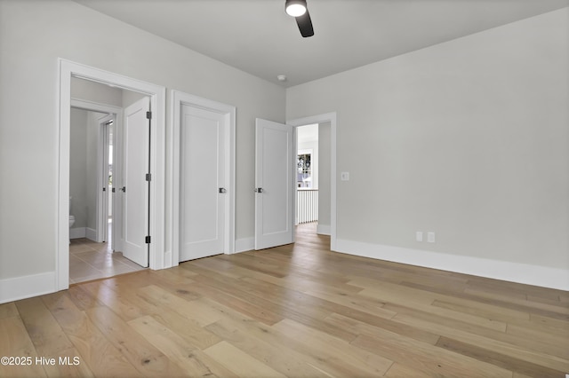 unfurnished bedroom with connected bathroom, ceiling fan, and light wood-type flooring