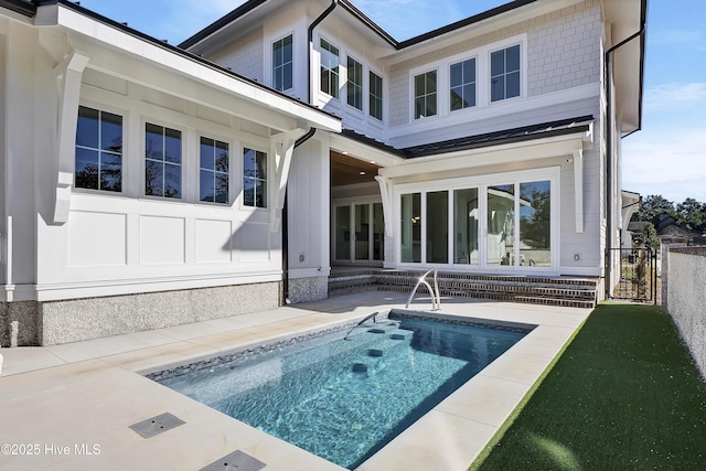 rear view of property featuring a patio area