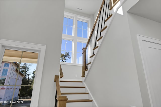 stairway featuring a high ceiling