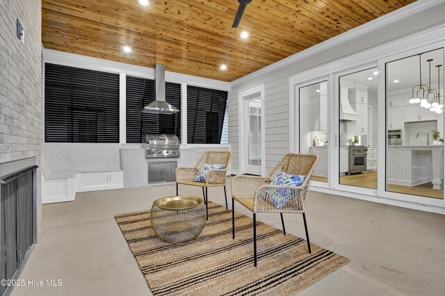 sunroom / solarium featuring sink and wooden ceiling