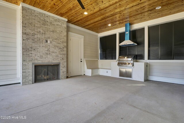 view of patio with an outdoor fireplace, a grill, and exterior kitchen