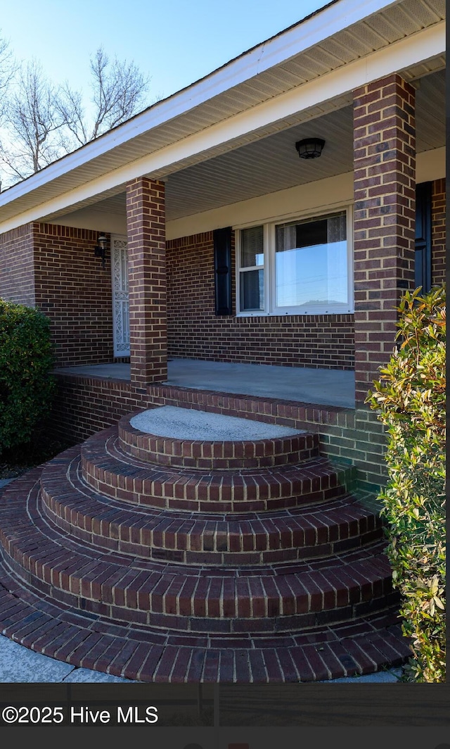 entrance to property featuring covered porch