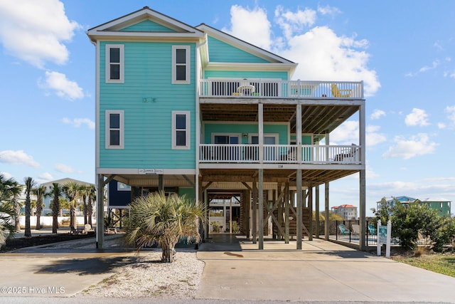 view of front of home with a balcony and a carport