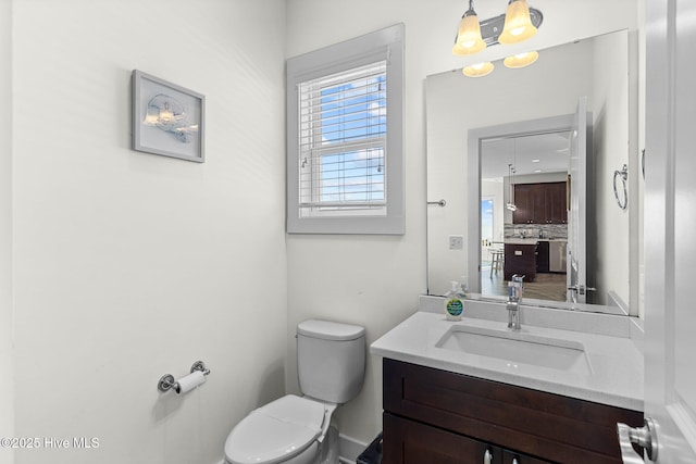 bathroom featuring toilet and vanity