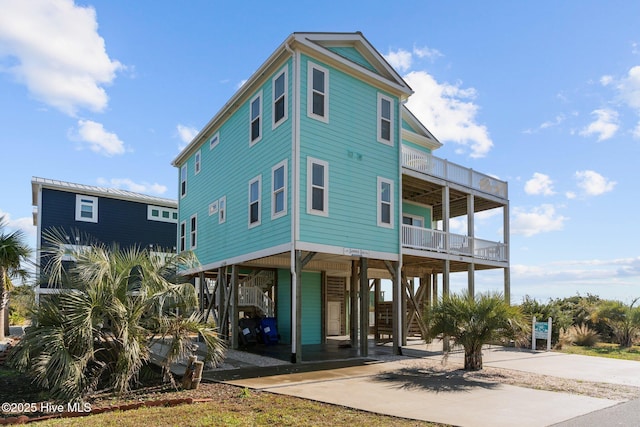 back of property with a carport and a balcony