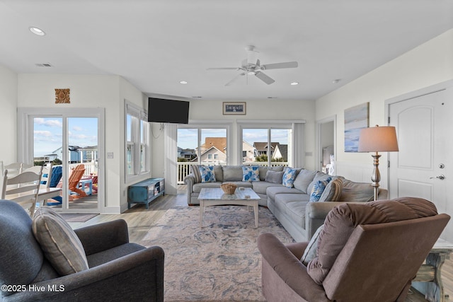 living room with visible vents, recessed lighting, a ceiling fan, and wood finished floors