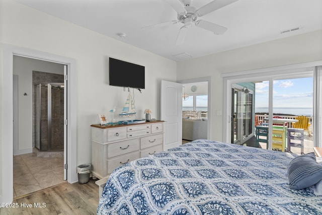 bedroom featuring visible vents, light wood-style floors, access to exterior, and a ceiling fan