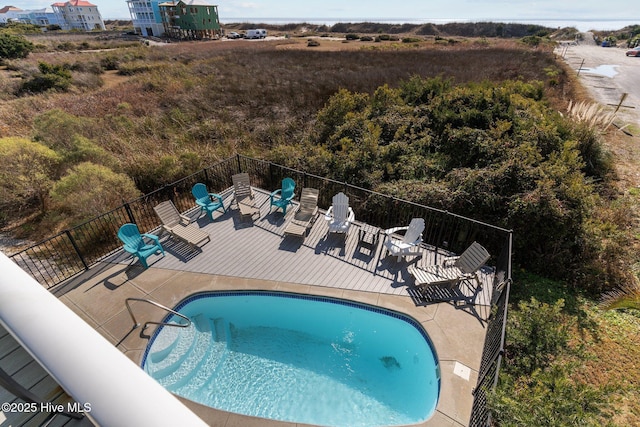 view of pool featuring a patio area, a fenced in pool, and fence