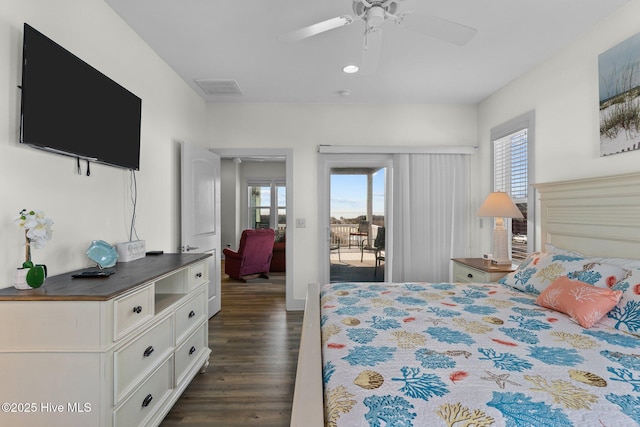 bedroom with access to exterior, visible vents, multiple windows, and dark wood-type flooring