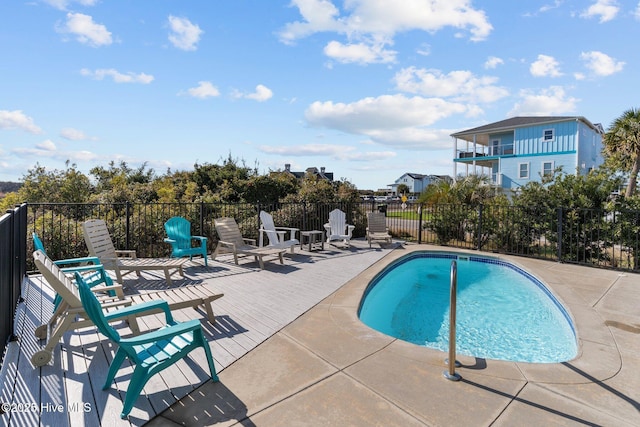 community pool featuring a patio and fence