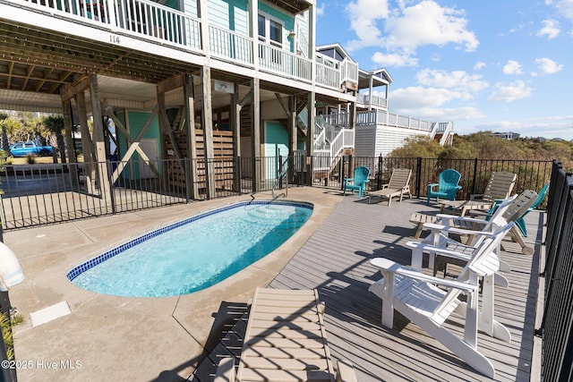 view of swimming pool with stairs, a patio, a fenced in pool, and fence