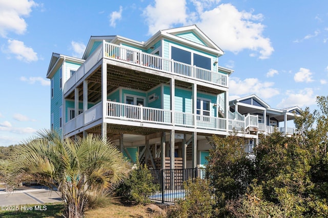 raised beach house featuring stairs