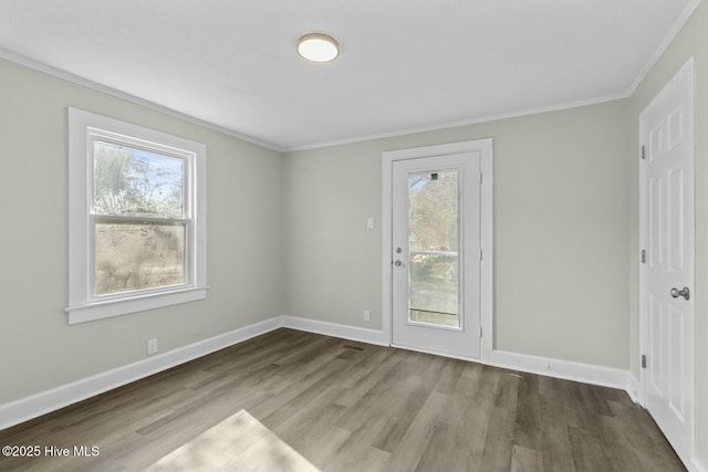 empty room with wood-type flooring and ornamental molding