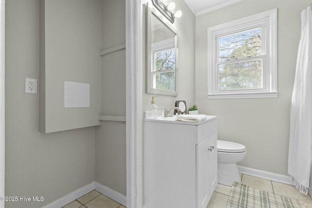 bathroom with tile patterned flooring, vanity, and toilet