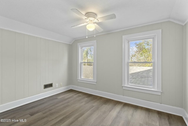 unfurnished room featuring ceiling fan, plenty of natural light, and vaulted ceiling