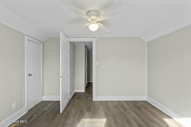 empty room featuring hardwood / wood-style flooring, ceiling fan, and vaulted ceiling