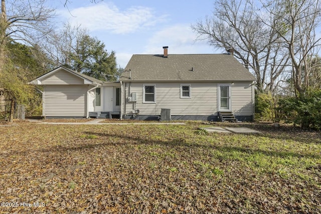 back of house with a yard and central AC